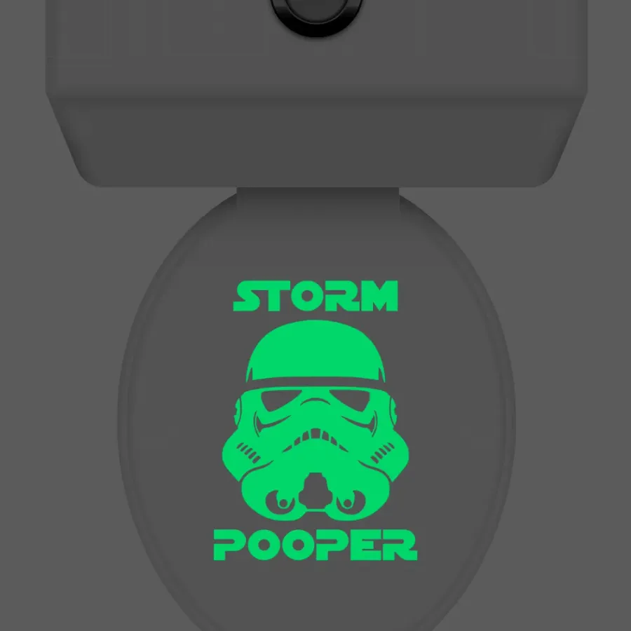 Storm Pooper decal glowing green on a toilet lid seen from above, labeled Glows in the Darkness